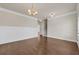 View of spacious dining room with hardwood floors, chandelier, and staircase nearby at 5140 Woodline View Cir, Auburn, GA 30011
