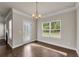 Inviting dining room featuring hardwood floors, a glass door, and backyard view at 5140 Woodline View Cir, Auburn, GA 30011