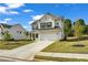 Well maintained two-story home with attached two car garage, nice landscaping and manicured lawn at 5140 Woodline View Cir, Auburn, GA 30011