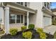 Two-story home with a brick facade, black shutters, front porch and attached two car garage at 5140 Woodline View Cir, Auburn, GA 30011