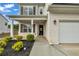 Two-story home with a brick facade, black shutters, front porch and attached two car garage at 5140 Woodline View Cir, Auburn, GA 30011