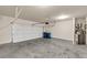 Spacious two car garage with concrete floors and an automatic door opener at 5140 Woodline View Cir, Auburn, GA 30011