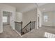 Upstairs hallway boasting natural light, with view of stairs and multiple rooms at 5140 Woodline View Cir, Auburn, GA 30011