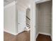 Hallway area leading to stairs, showing doorway to a shelved closet for storage at 5140 Woodline View Cir, Auburn, GA 30011