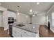 Open concept kitchen with granite countertops and stainless steel appliances at 5140 Woodline View Cir, Auburn, GA 30011