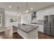 Modern kitchen with a granite island, stainless steel appliances, and white cabinetry at 5140 Woodline View Cir, Auburn, GA 30011