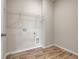 Convenient laundry room with hardwood style floors and ample space for appliances at 5140 Woodline View Cir, Auburn, GA 30011