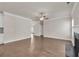 Bright living room featuring hardwood floors, crown molding, and a ceiling fan at 5140 Woodline View Cir, Auburn, GA 30011