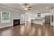 View of living room with hardwood floors, fireplace, and kitchen with bar seating at 5140 Woodline View Cir, Auburn, GA 30011