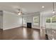 Cozy living room with fireplace, hardwood floors, and large windows at 5140 Woodline View Cir, Auburn, GA 30011
