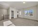 Bright loft featuring neutral carpeting and windows with views of the neighborhood at 5140 Woodline View Cir, Auburn, GA 30011