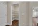 Walk-in pantry with white shelving and wood flooring, ideal for organized storage at 5140 Woodline View Cir, Auburn, GA 30011