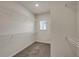 Spacious walk-in closet featuring built-in shelving and a window for natural light at 5140 Woodline View Cir, Auburn, GA 30011