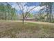 This beautiful backyard features mature trees and a serene atmosphere, offering an excellent outdoor experience at 6435 E Glen Rd, Lithonia, GA 30038