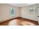 Cozy bedroom featuring hardwood floors and windows that offer great views of the surrounding neighborhood at 6435 E Glen Rd, Lithonia, GA 30038