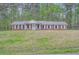 Charming brick home featuring a well-manicured lawn and a classic symmetrical design at 6435 E Glen Rd, Lithonia, GA 30038