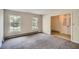 Spacious living room with neutral carpet, light walls, and natural light from two windows at 6435 E Glen Rd, Lithonia, GA 30038