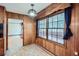 Cozy sunroom with large windows, wood paneling, and tiled flooring at 6435 E Glen Rd, Lithonia, GA 30038