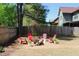 A backyard featuring a fire pit area with colorful Adirondack chairs, ideal for relaxing and entertaining guests at 307 Downing Creek Trl, Canton, GA 30114