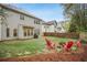 A spacious backyard with a fire pit area and Adirondack chairs, backs up to other homes at 307 Downing Creek Trl, Canton, GA 30114