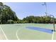 Outdoor basketball court featuring multiple hoops with green and blue accents at 307 Downing Creek Trl, Canton, GA 30114