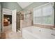 Beautiful bathroom featuring a tub and separate glass shower with neutral tile at 307 Downing Creek Trl, Canton, GA 30114