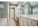 Bright bathroom with double vanity, white cabinetry, and separate tub at 307 Downing Creek Trl, Canton, GA 30114