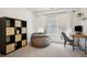 Versatile bedroom ideal for study or relaxation, with a desk, chair, and storage unit at 307 Downing Creek Trl, Canton, GA 30114