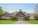A beautiful clubhouse with stone accents and a covered entrance surrounded by landscaped grounds at 307 Downing Creek Trl, Canton, GA 30114