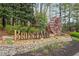 A community entrance featuring a stone wall with 'BridgeMill' signage and landscaping at 307 Downing Creek Trl, Canton, GA 30114
