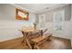 Dining room with natural light, wainscoting, and a rustic wooden table with bench at 307 Downing Creek Trl, Canton, GA 30114