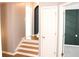 Inviting entryway with hardwood floors, staircase, and white doors at 307 Downing Creek Trl, Canton, GA 30114