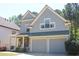 Charming two-story home with a covered front porch, stone accents, and a two-car garage at 307 Downing Creek Trl, Canton, GA 30114