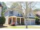 Charming two-story home with a covered front porch, stone accents, and a two-car garage at 307 Downing Creek Trl, Canton, GA 30114