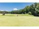 Enjoy a relaxing round of golf on this beautiful green golf course with mature trees at 307 Downing Creek Trl, Canton, GA 30114