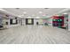 Brightly lit gym with light wood floors, mirrored wall, and exercise equipment at 307 Downing Creek Trl, Canton, GA 30114