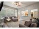 Spacious living room featuring hardwood floors, a ceiling fan, and an opening to the kitchen at 307 Downing Creek Trl, Canton, GA 30114