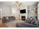 Cozy living room with fireplace, ceiling fan and hardwood floors at 307 Downing Creek Trl, Canton, GA 30114