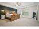 Spacious main bedroom features a tray ceiling, carpeted floors, and stylish accent wall at 307 Downing Creek Trl, Canton, GA 30114