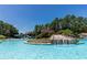Community pool with waterfall, water slide, and surrounded by lush trees at 307 Downing Creek Trl, Canton, GA 30114