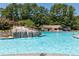 Beautiful pool with waterfall feature and surrounding lush landscape at 307 Downing Creek Trl, Canton, GA 30114