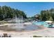 Community pool with splash pad and water slide surrounded by lush trees at 307 Downing Creek Trl, Canton, GA 30114