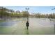 Wide view of multiple community tennis courts with surrounding greenery at 307 Downing Creek Trl, Canton, GA 30114