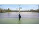 Close-up shot of community tennis court with net and lighting at 307 Downing Creek Trl, Canton, GA 30114