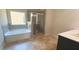 Bright bathroom features a soaking tub with a shower, a glass door shower, and a double sink vanity at 5243 Cantbury Way, Atlanta, GA 30349