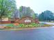 Parkway Villages entrance with a stone sign, colorful flowers, lush trees, and a welcoming neighborhood atmosphere at 5243 Cantbury Way, Atlanta, GA 30349