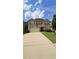 Charming two-story home featuring a large driveway, two-car garage, and well-maintained landscaping at 5243 Cantbury Way, Atlanta, GA 30349