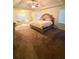 Spacious main bedroom with a trey ceiling, a large bed, and natural light at 5243 Cantbury Way, Atlanta, GA 30349