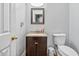 Bathroom features a granite vanity, framed mirror and toilet at 642 Towering Pine Trl, Lawrenceville, GA 30045