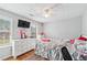 Well-lit bedroom featuring a large dresser and a ceiling fan at 642 Towering Pine Trl, Lawrenceville, GA 30045